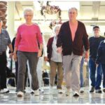 group of seniors walking in a mall