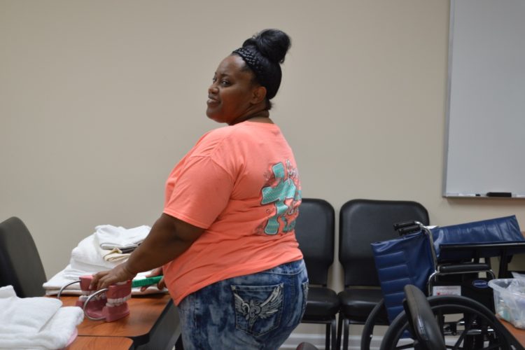 Schmieding CNA student practices teeth-brushing skills.