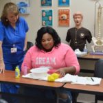 CNA student practices nail care