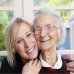 Young caregiver with elder woman